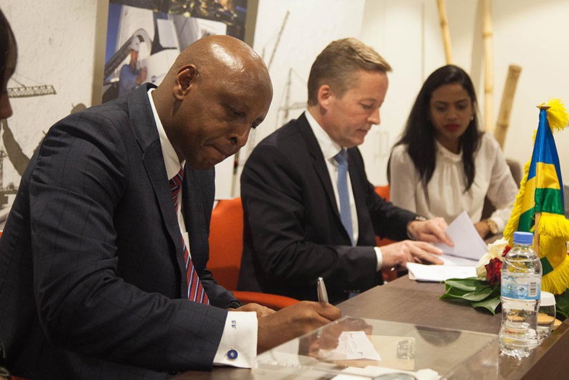 Alexis Bayigamba and the CEO of FLSmidth, Anders Bech signing agreements.