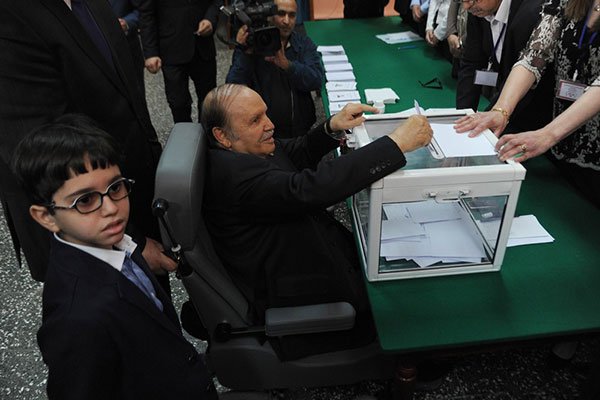 Algeria's ailing President Abdelaziz Bouteflika casts his ballot from a wheelchair in Algiers on April 17, 2014. His party chief says he is OK after a health scare.
