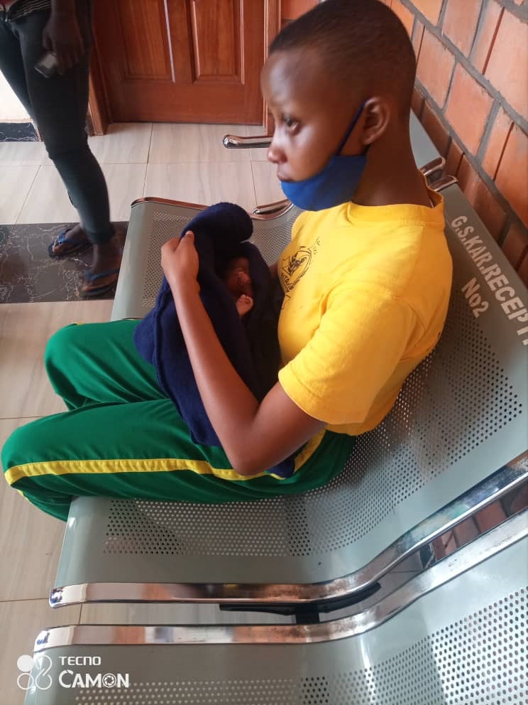 Umuhoza holding the abandoned baby. 