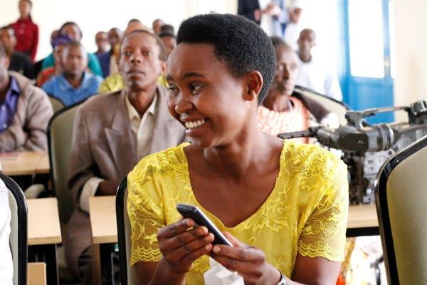 An excited volunteer after receiving a phone and sim card