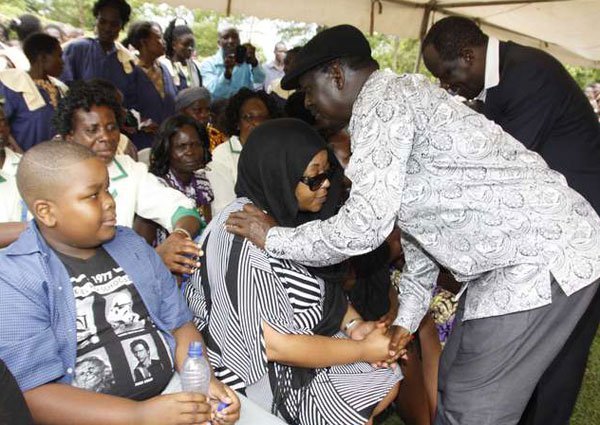 Cord leader Raila Odinga condoles Jacob Juma's widow Miriam at her home in Khasoko, Bungoma County, on May 13, 2016. Mr Odinga poured scorn on official statements that police were investigating the killing.