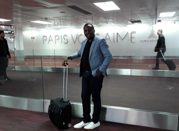 Dr. Francis Habumugisha posted a picture of himself showing he was at an airport in France.