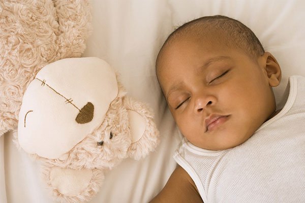 To reduce the risk of sudden death, babies should sleep in the same room as their parents but in their own crib or bassinet for the first year of life, US doctors said Monday.