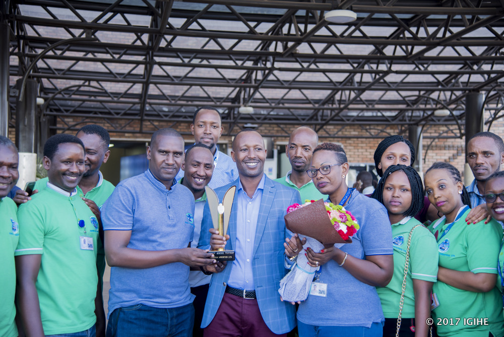 Fred Seka (C) and the company staff share light moments while celebrating the award.
