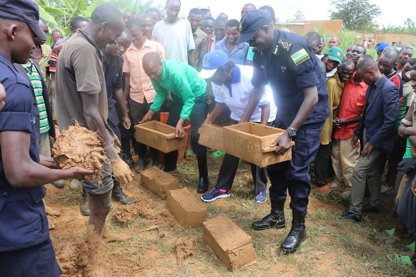 Minister Alivera Mukabaramba, CP John Bosco Kabera in Umuganda laying bricks for the construction of toilets.
