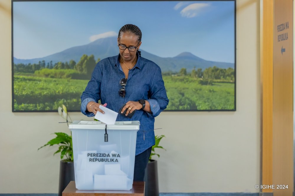 Mrs. Jeannette Kagame places a ballot paper in the box after voting.