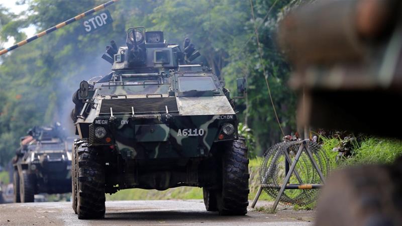 An armoured Personnel Carrier drives to a military camp to reinforce government soldiers in Marawi