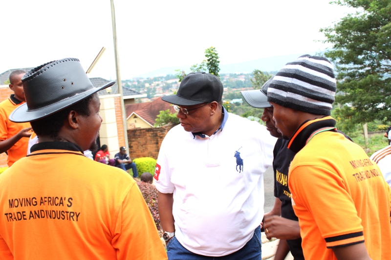 Kenyan ambassador to Rwanda, John Mwangemi along with emplyees of African Logistics in community work