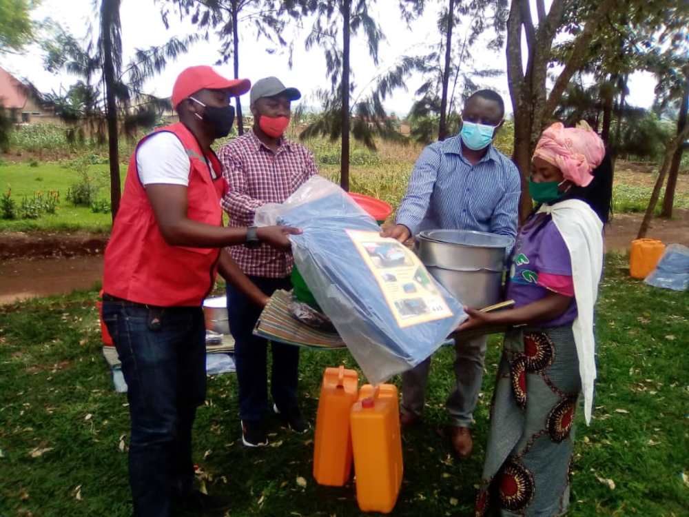 Red Cross Rwanda staff donating home items to one of disaster-affected residents.