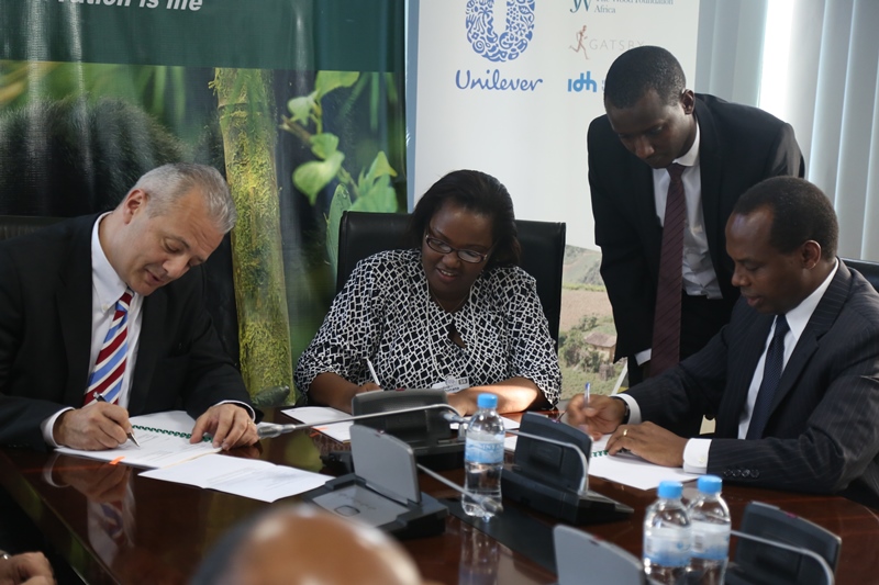 Camille Chammas who represented Unilever (on the left),the Minister of Agriculture and Aniamal Ressources,Mukeshimana Geraldine and the CEO of RDB Francis Gatare signing agreements  