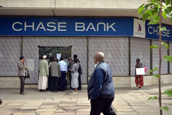 Chase Bank customers read a closure notice at Mama Ngina Street branch in Nairobi, April 7, 2016 after the bank was put in receivership by the Central Bank of Kenya.