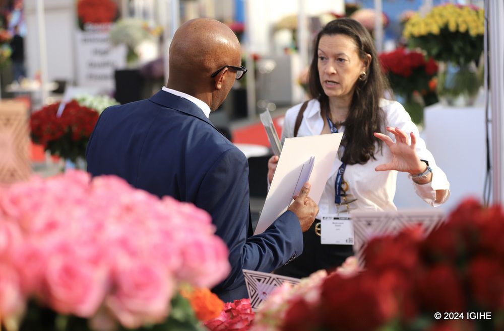 A visitor receiving explanations about Rwanda's floral offerings.