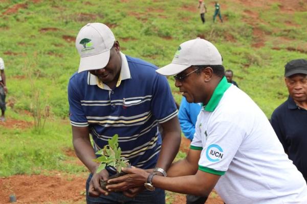 Dr Vincent Biruta and Kidega get ready to plant trees