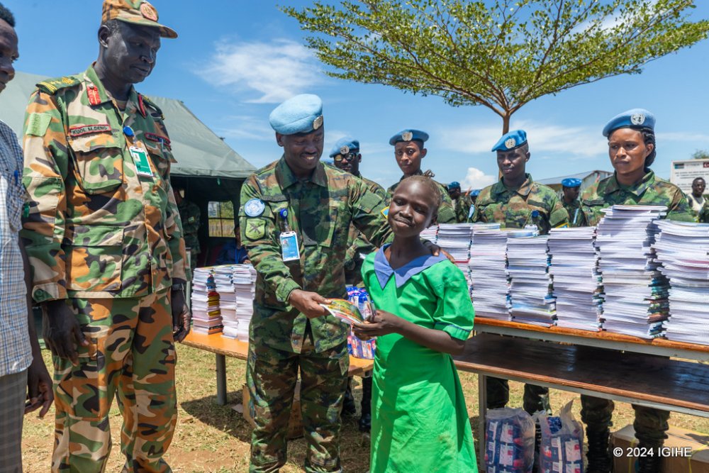 Rwandan soldiers distributing school supplies and hygiene products to students. 