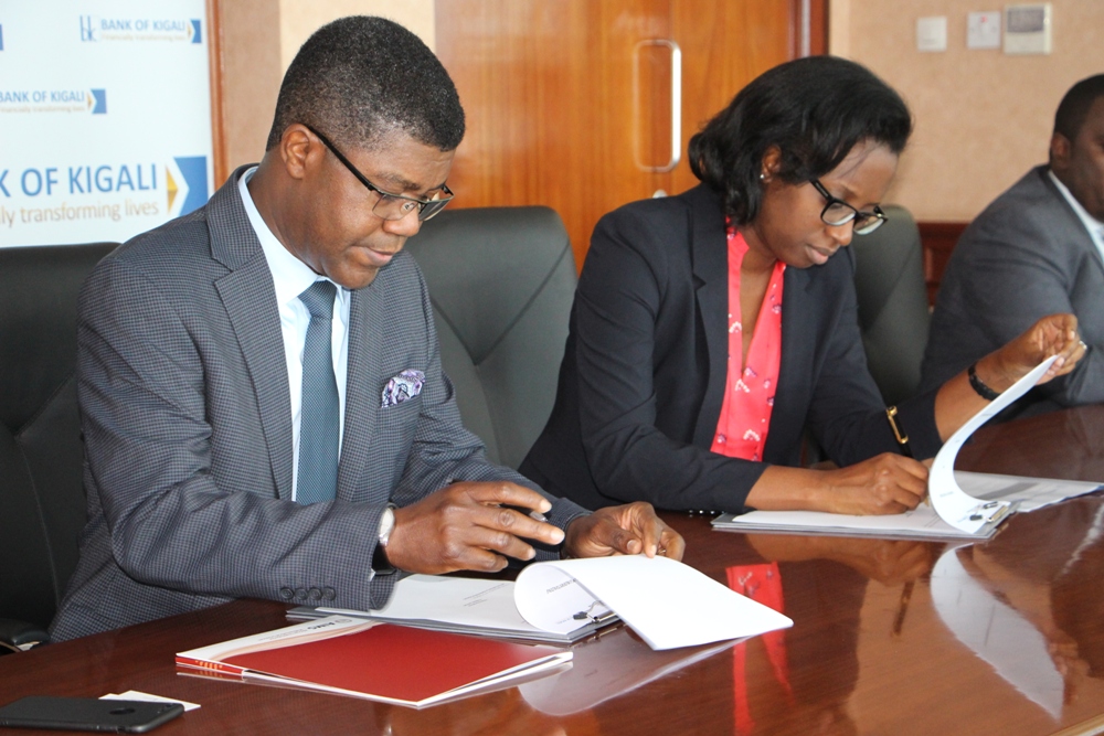 Thierry Zomahoun, President and CEO of AIMS and Dr. Diane Karusisi, Bank of Kigali Chief Executive Officer sign MoU