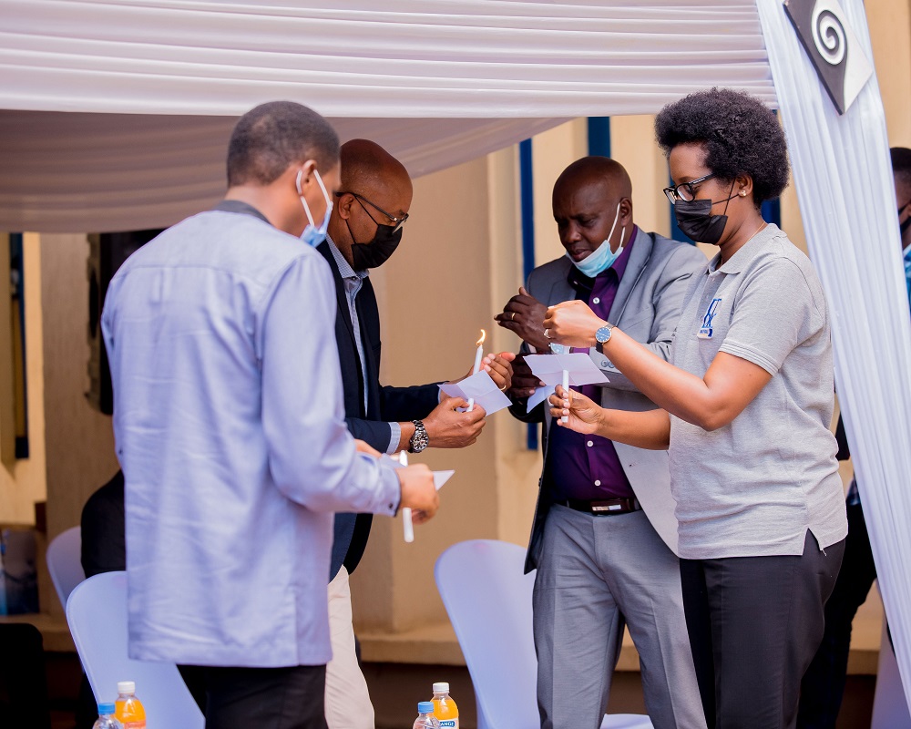 The CEO of BK, Dr. Diane Karusisi with other participants of the event lighting the flame of remembrance.
