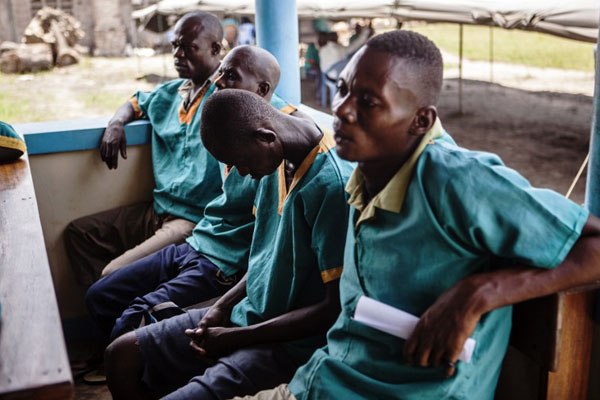 Accused Congolese soldiers sit at the Military Tribunal of Kinshasa during the trial of Congolese MINUSCA (United Nations Multidimensional Integrated Stabilization Mission in the Central African Republic) soldiers on April 4, 2016.