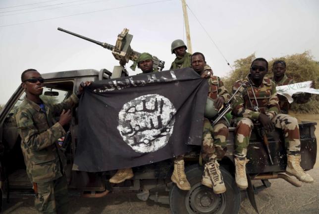 Nigerian soldiers hold up a Boko Haram flag that they had seized in the recently retaken town of Damasak, Nigeria, March 18, 2015. REUTERS/Emmanuel Braun Nigerian soldiers hold up a Boko Haram flag that they had seized in the recently retaken town of Damasak, Nigeria, March 18, 2015.