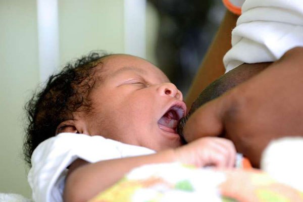 A mother breastfeeds her baby. Children breastfed exclusively for their first six months of life have an easier time behaving as primary school students, according to new research published Tuesday.