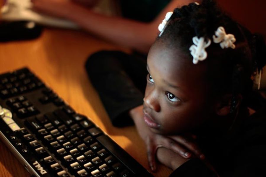 A girl learns how to use a computer key board. Gender stereotypes emerge early, and by age six, girls are less likely to believe females are "brilliant" and more likely to believe boys are, according to a study released Thursday. 