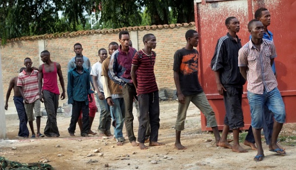 In this Saturday, Dec. 12, 2015 file photo, men captured by the security forces, who were said by them to have been involved in attacks on military targets but which could not be independently verified, are paraded during a press conference at the country’s intelligence service headquarters in the capital Bujumbura, Burundi.