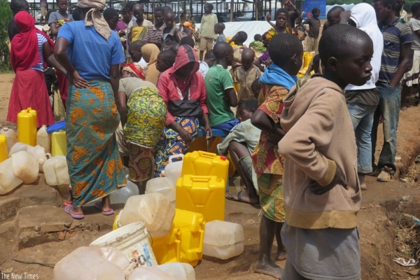 Burundian refugees waiting in a queue to fetch water in Mahama Camp