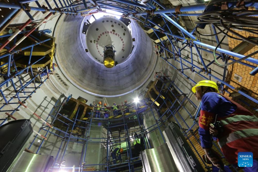 The first reactor pressure vessel of Shidaowan high temperature gas-cooled reactor nuclear power plant is hoisted in place on March 20, 2016. (Photo by Ma Yuejun/Xinhua)