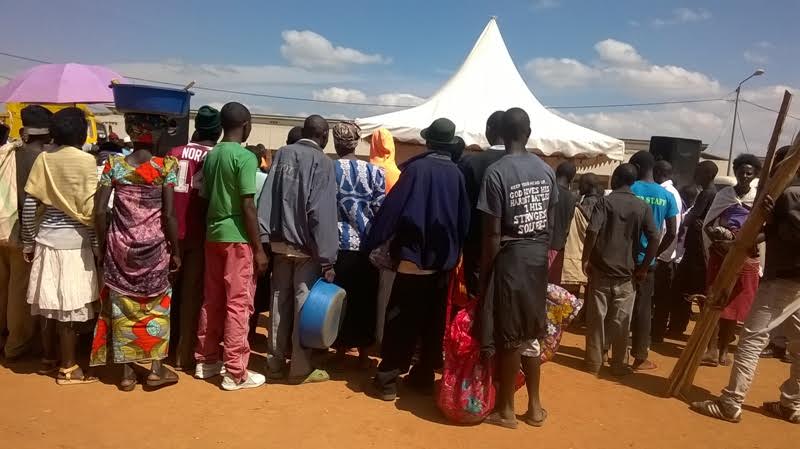 Duterimbere employees explaining to Muhanga residents about their services.