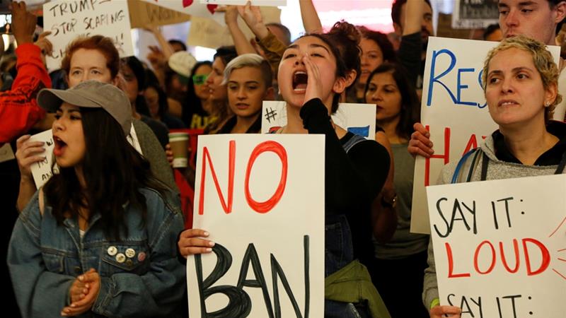 Demonstrators yell slogans against the travel ban at Los Angeles International Airport
