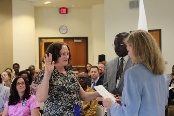 Marcia Musisi-Nkambwe (left) recites the oath of office to Ambassador Erica J. Barks-Ruggles (right): Photo Courtesy USAID/Rwanda