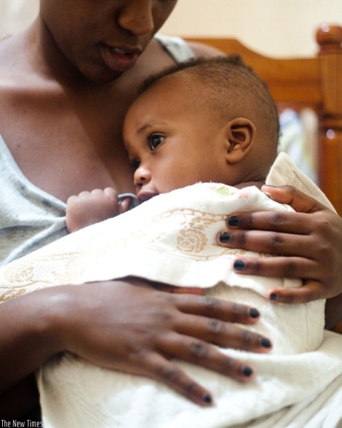 A mother carries her child