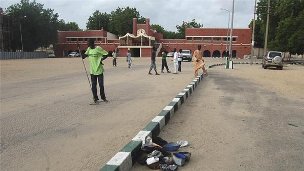 People walk in front of a mosque after a bomb attack in Maiduguri in 2012
