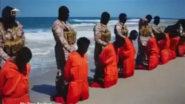An image grab taken from a video reportedly released by the Daesh Takfiri terrorist group on May 11, 2016, shows men described as Ethiopian Christians kneeling on the ground in front of masked terrorists on a beach at an undisclosed location in Libya.