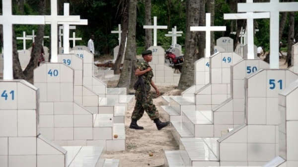 A Burundian soldier patrols in a cemetry.