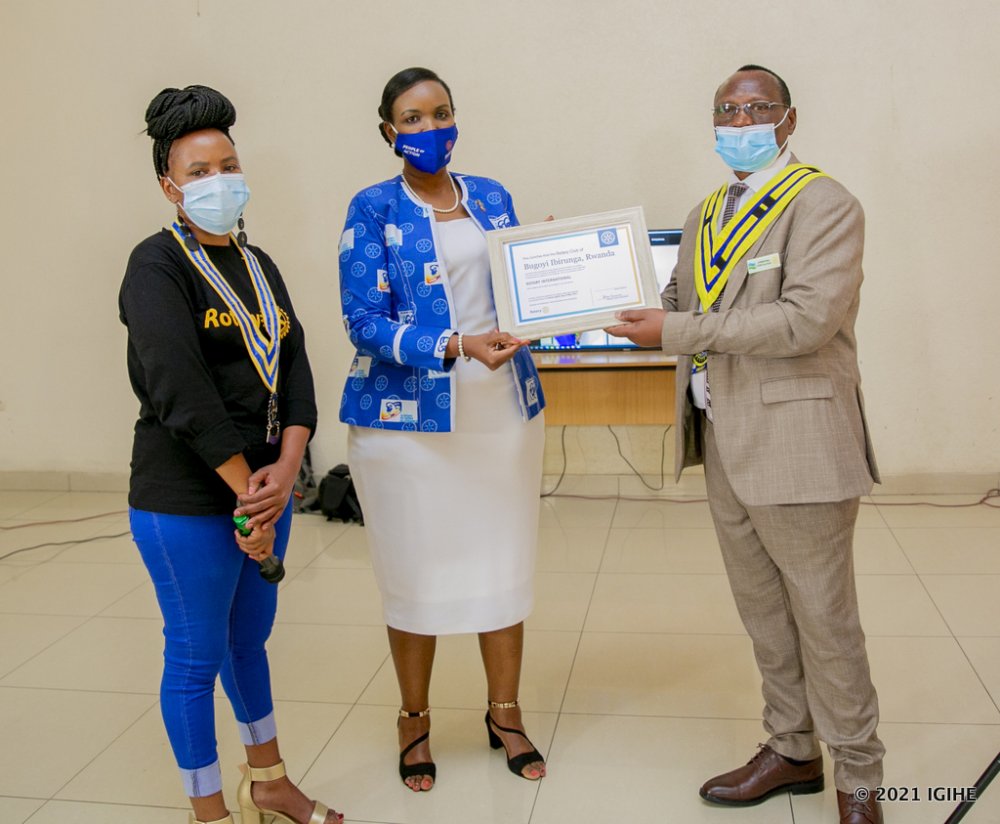 The President of Rotary Club Bugoyi Ibirunga, Bishop Jean Faustin Gapira (right) receiving Charter Certificate.