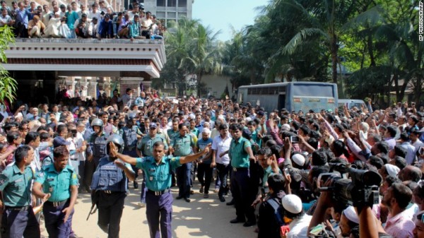 People gather outside a court as police escort the accused in the killing of Samiul Islam Rajon before a verdict in Sylhet, Bangladesh, on November 8, 2015