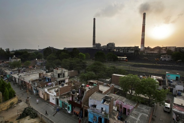 Emissions billow from smokestacks at a coal-fired power plant near residential property in Badarpur, Delhi, India.