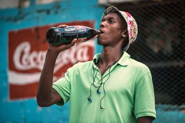 A man drinking soft drink “Coca Cola” in the Township of Zandspruit, Greater Johannesburg, South Africa.