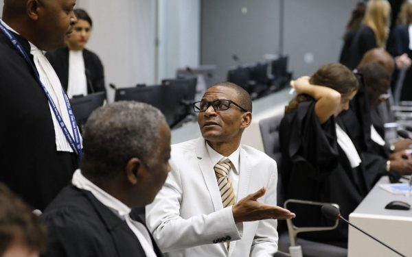 Narcisse Arido (C) of the Central African Republic talks with his lawyer in the courtroom of the International Criminal Court (ICC) in The Hague, on October 19, 2016.