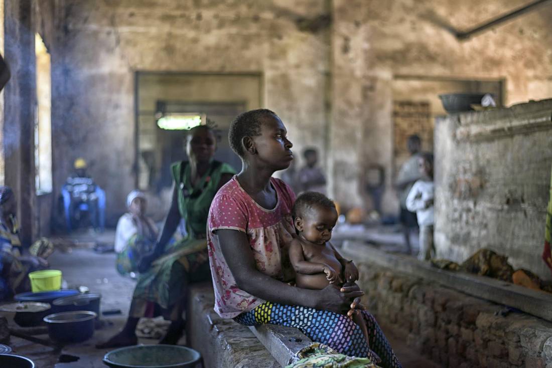 A displaced woman and her baby, from a forest-dwelling hunter-gatherer group in Congo, live in an abandoned factory in Nyunzu, Congo, March 22, 2016. Traditional forest dwellers, known for their capacity to co-operate, have become embroiled in and displaced by one of the conflicts that typify the Democratic Republic of Congo as an election crisis looms.