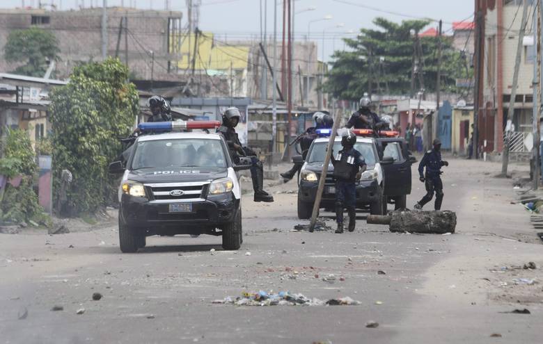 Riot police remove a barricade used to block a road during a protest in Kinshasa, Democratic Republic of Congo, Tuesday, Dec. 20, 2016. Human Rights Watch says security forces have killed three people in Congo’s capital and arrested scores more amid protests against President Joseph Kabila’s hold on power.