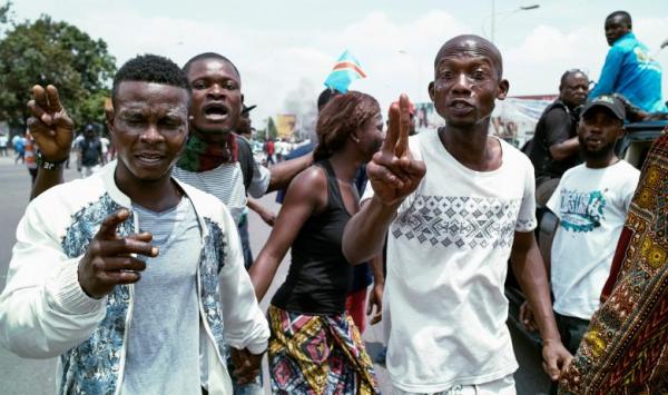 Congolese opposition activists gesture during a march to press President Joseph Kabila to step down in the Democratic Republic of Congo's capital Kinshasa, September 19, 2016.