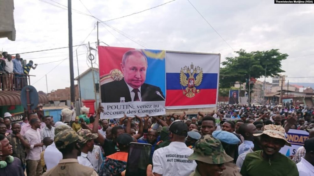 Protestors holding banners requesting for the support of Russian President Putin.