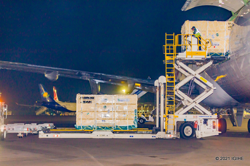 Trucks offloading crates containing translocated rhinos upon arrival at Kigali International Airport.  