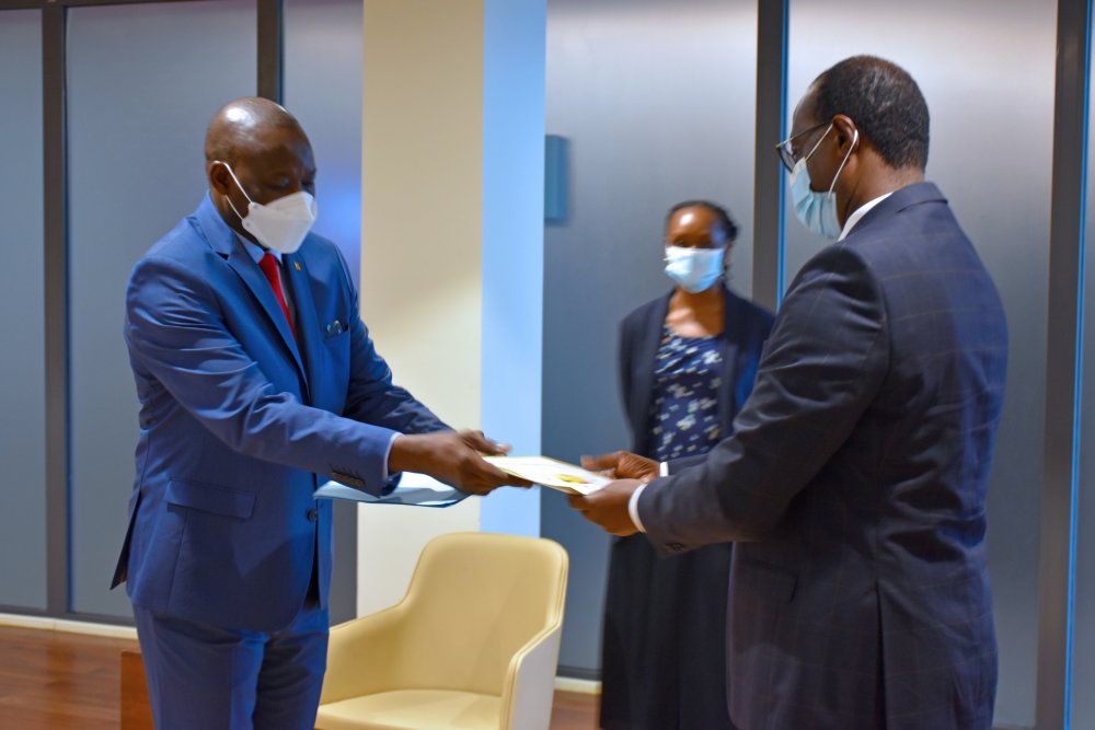The Minister of State in the Ministry of Foreign Affairs and International Cooperation in Charge of East African Community, Prof Nshuti Manasseh exchanging documents with Ambassador-Designate, Doudou Sow of Senegal to Rwanda.  