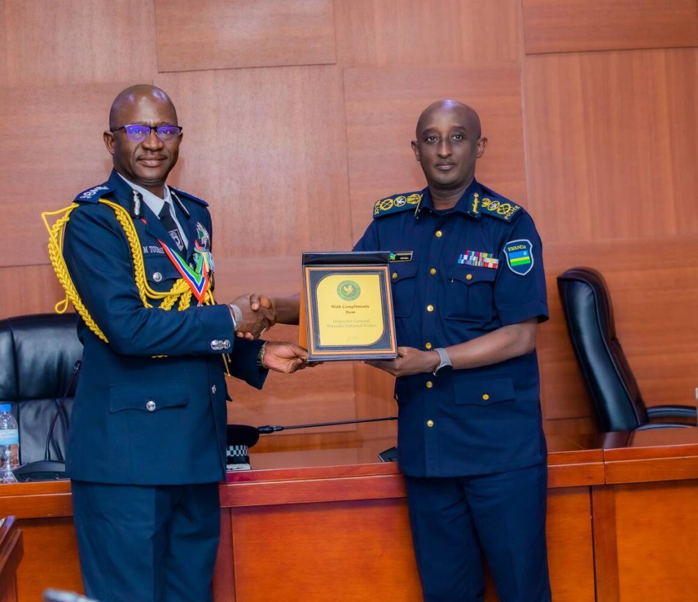 The Inspector General of Police  (IGP), CG Felix Namuhoranye (right) welcoming his counterpart of The Gambia Police Force Gen Seedy Muctar Touray.