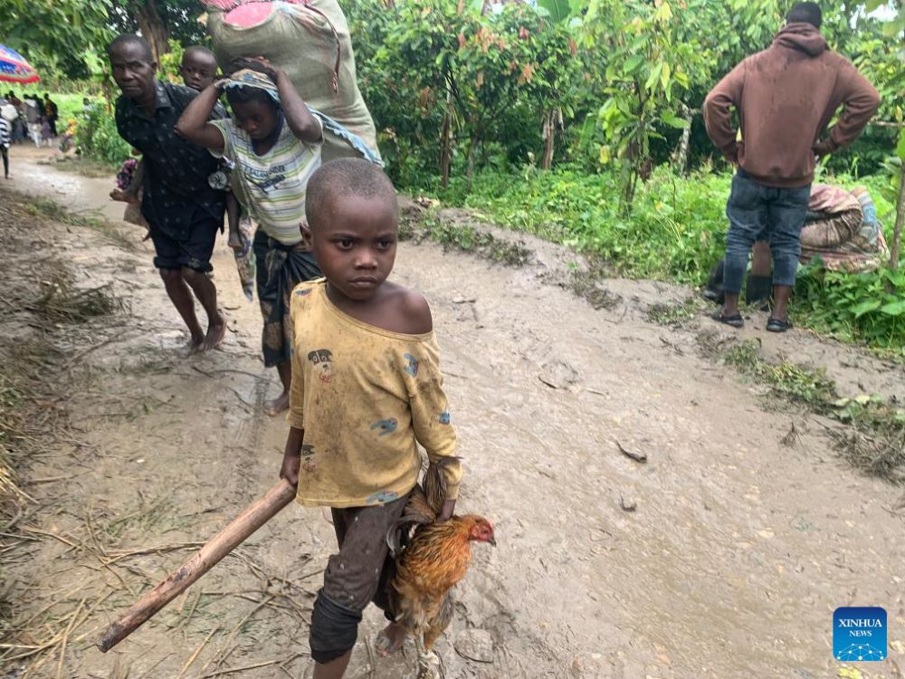 Congolese refugees are on their way to a holding center in the district of Bundibugyo, western Uganda, on Nov. 13, 2023. More than 1,000 refugees from the Democratic Republic of the Congo (DRC) have fled to Uganda following recent attacks by suspected Allied Democratic Forces (ADF) rebels, according to a local humanitarian organization. (Photo by Geoffrey Nyamwongera/Xinhua)