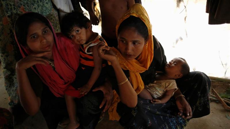 Rohingya refugees sit inside their home at a refugee camp in Bangladesh