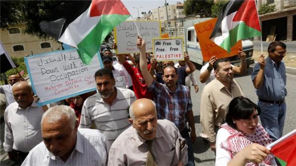 Palestinians during a protest rally to mark the 49th anniversary of what they call 'Naksa Day'