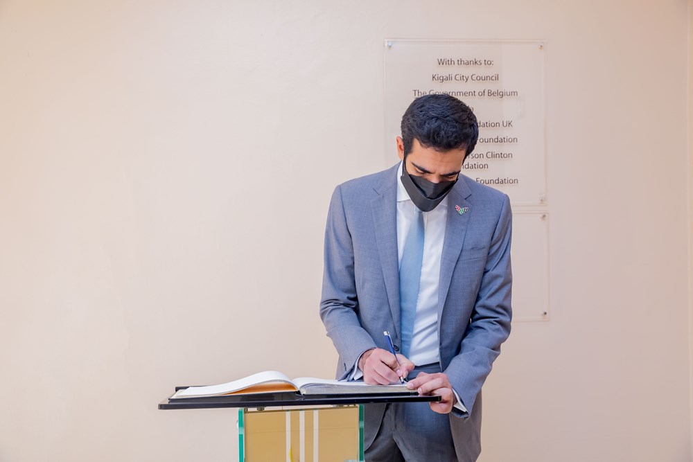 Sheikh Shakhboot writing the the memorial's guest book.  